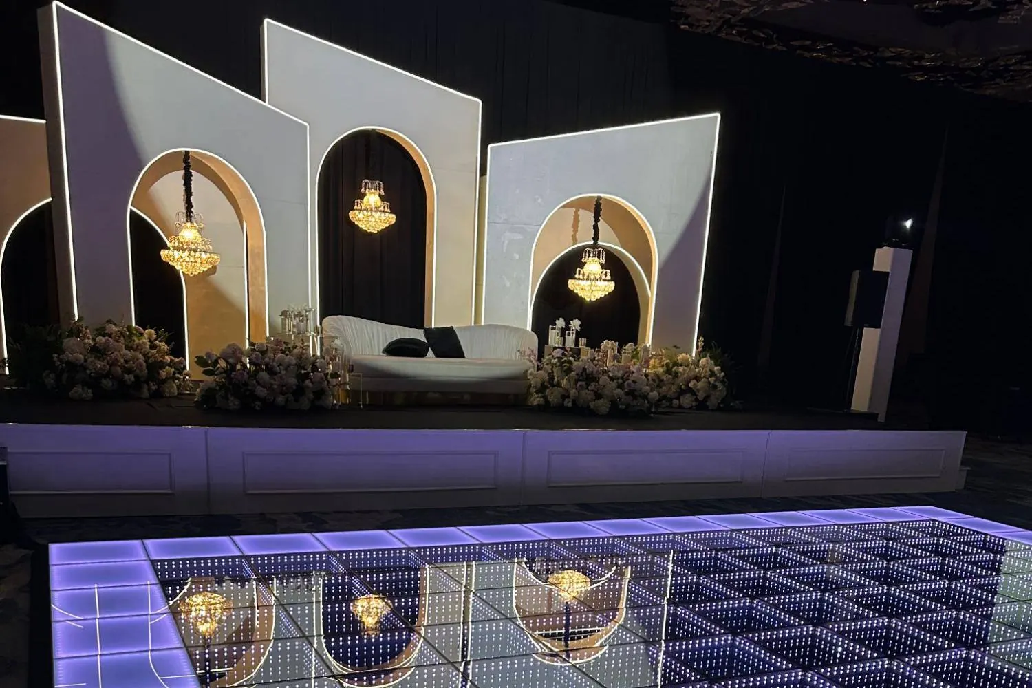 Close-up of infinity mirror LED dance floor panels at a hotel ballroom event