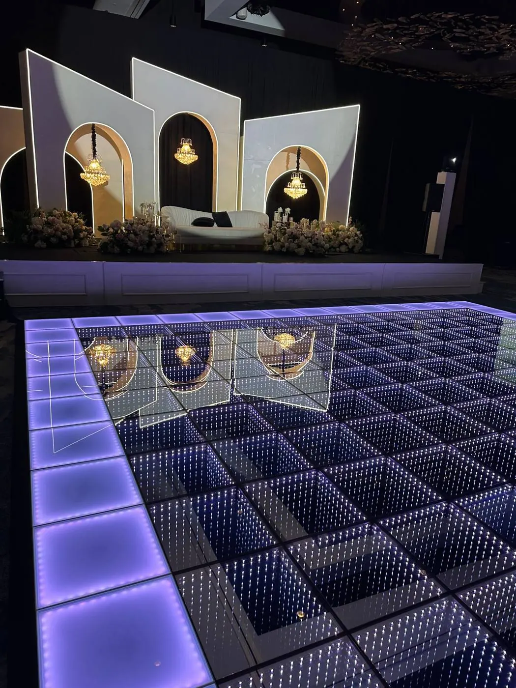 Infinity mirror LED dance floor panels glowing at a hotel ballroom event