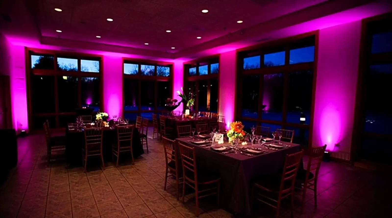 Sample event uplighting look washing the walls of a reception venue in color